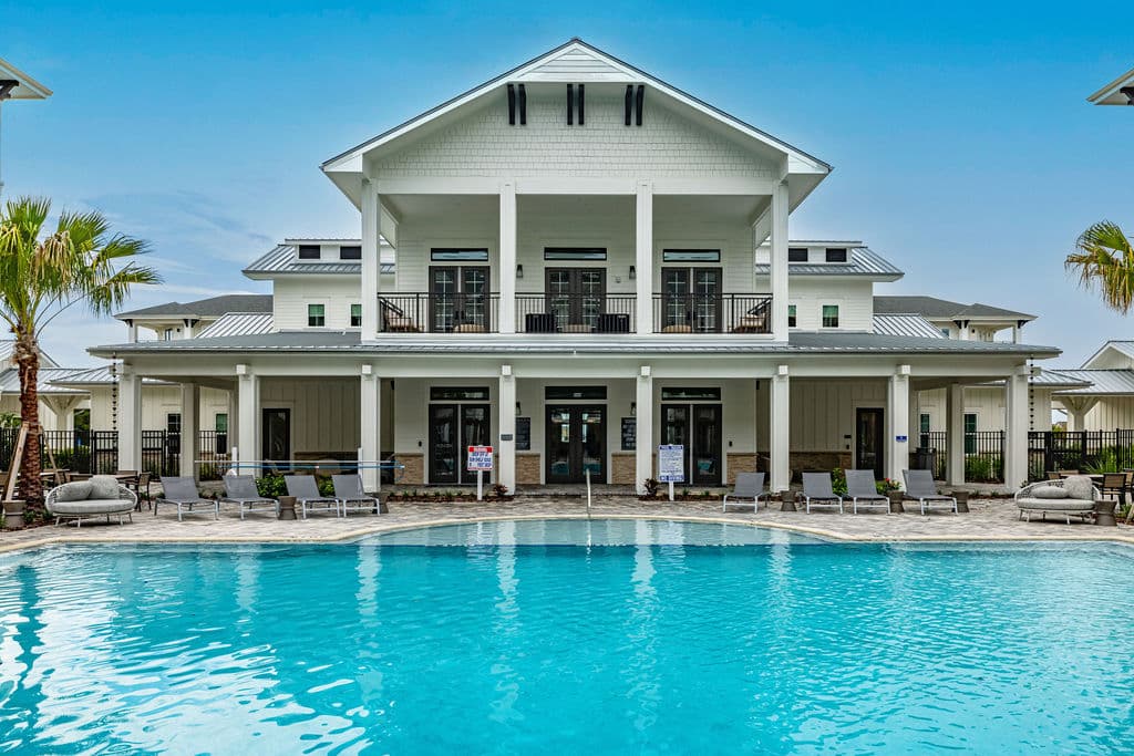 A large pool with lounge chairs in front of Ridley at Waterset's clubhouse in Apollo Beach, FL.